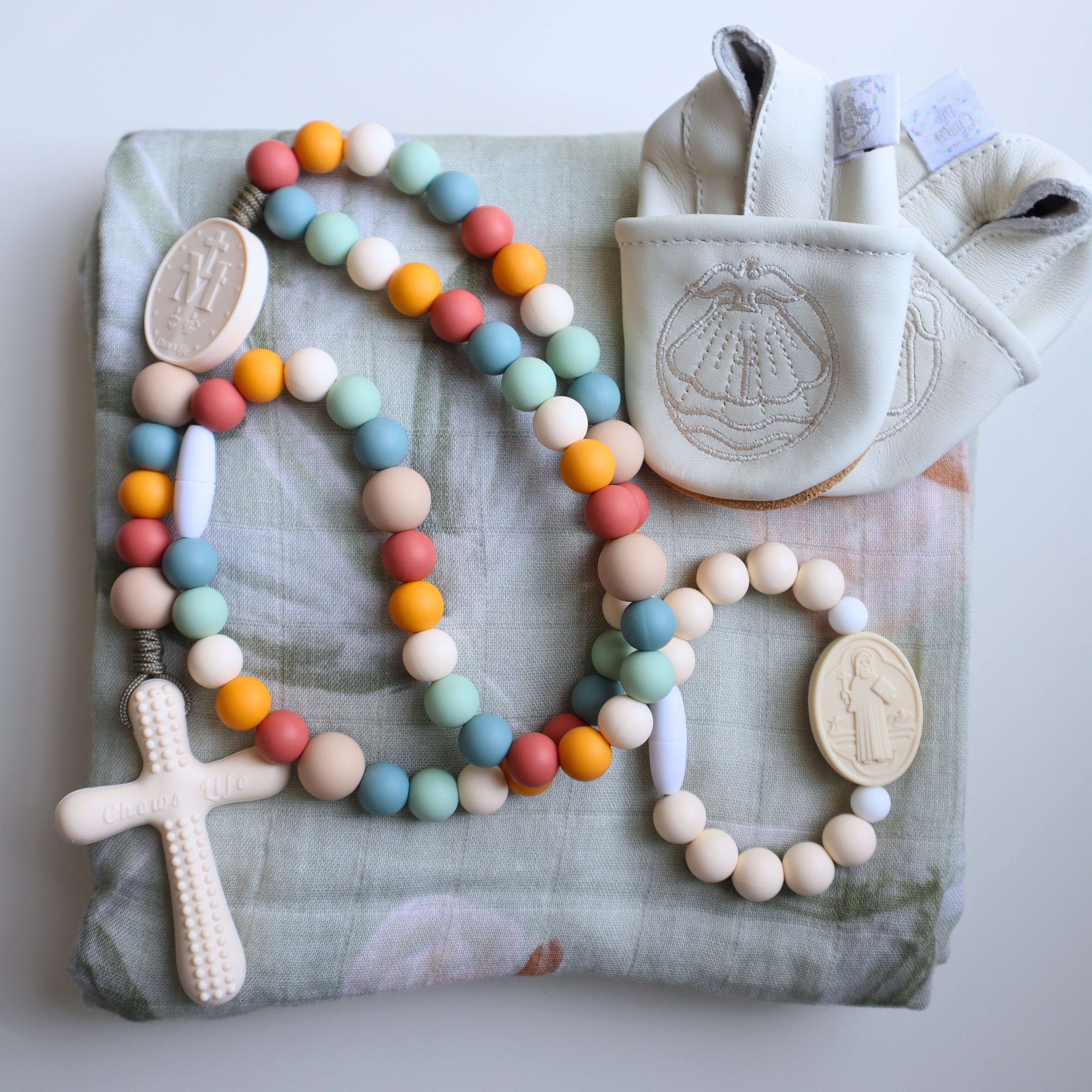 Deluxe Baby Gift Set | Silicone Rosary & Saint Bracelet, Swaddle & Emmaus Crib Shoes