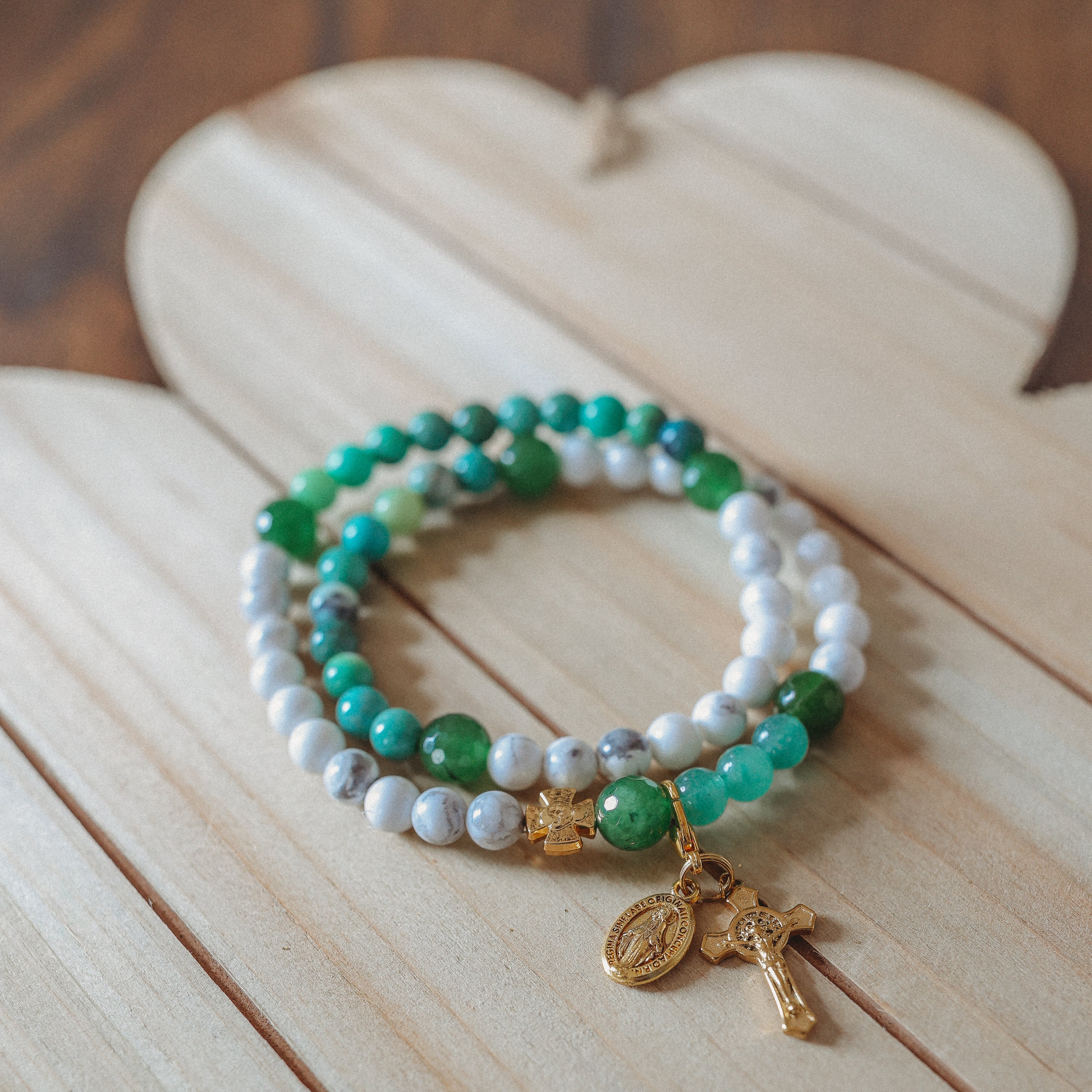 Rosary bracelet with green and white beads alternating and gold accents including a moveable bookmark charm